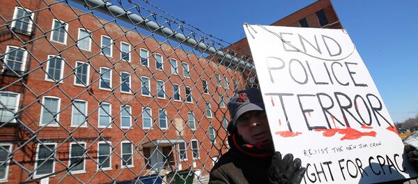 A protestor stands outside a police facility called Homan Square, demanding an investigation into a media report denied by police that the site functions as an off-the-books interrogation compound, in Chicago, Illinois, March 5, 2015 - Sputnik International