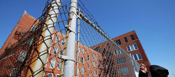 A protestor stands outside a police facility called Homan Square, demanding an investigation into a media report denied by police that the site functions as an off-the-books interrogation compound, in Chicago, Illinois, March 5, 2015 - Sputnik International