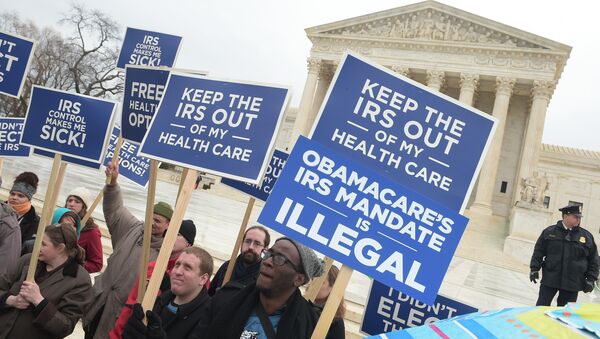 Protestors hold placards challenging Obamacare outside of the US Supreme Court on March 4, 2015 in Washington, DC - Sputnik International