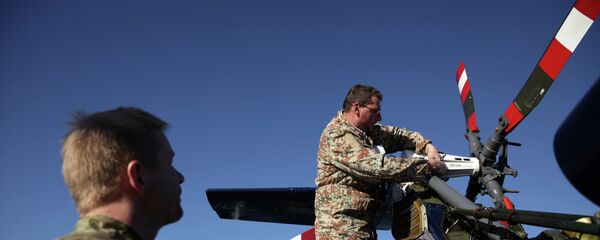 Danish soldiers from the Royal Danish Navy work at an helicopter onboard of the Absalon military ship in the Cypriot port city of Limassol - Sputnik International