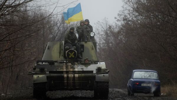 Ukrainian servicemen ride atop an armored vehicle with a Ukrainian flag, on the outskirts of Donetsk, Ukraine - Sputnik International