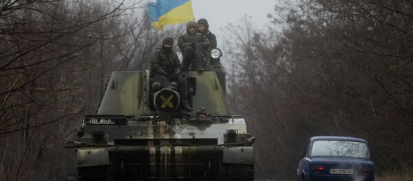 Ukrainian servicemen ride atop an armored vehicle with a Ukrainian flag, on the outskirts of Donetsk, Ukraine Ukrainian servicemen ride atop an armored vehicle with a Ukrainian flag, on the outskirts of Donetsk, Ukraine - Sputnik International