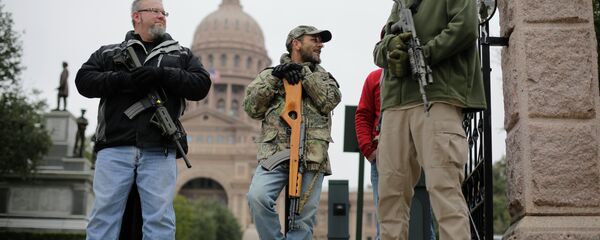 In this Jan. 13, 2015 file photo, gun rights advocates carry rifles while protesting outside the Texas Capitol in Austin, Texas In this Jan. 13, 2015 file photo, gun rights advocates carry rifles while protesting outside the Texas Capitol in Austin, Texas - Sputnik International