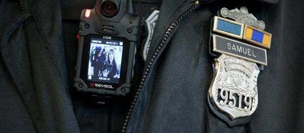 A Philadelphia Police officer demonstrates a body-worn camera A Philadelphia Police officer demonstrates a body-worn camera - Sputnik International