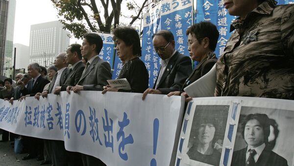 Holding a banner, reading We cannot put up with it anymore, relatives of Japanese abduction victims appeal support to help their missing family return home in downtown Tokyo Tuesday, Nov. 9, 2004 - Sputnik International