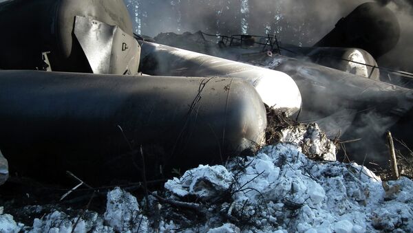 Tanker rail cars are seen lying on their side after a crude oil train derailment - Sputnik International