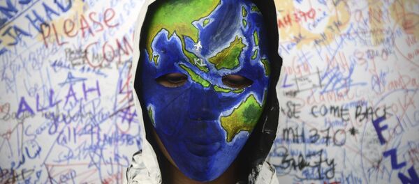 Аn unidentified woman wearing a mask depicting the flight of the missing Malaysia Airline, MH370, poses in front of the wall of hope at Kuala Lumpur International Airport in Sepang, Malaysia Аn unidentified woman wearing a mask depicting the flight of the missing Malaysia Airline, MH370, poses in front of the wall of hope at Kuala Lumpur International Airport in Sepang, Malaysia - Sputnik International