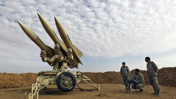 In this photo obtained from the Iranian Mehr News Agency, Iranian army members prepare missiles to be launched, during a maneuver, in an undisclosed location in Iran - Sputnik International