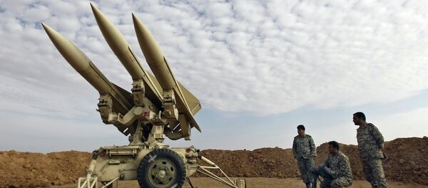 In this photo obtained from the Iranian Mehr News Agency, Iranian army members prepare missiles to be launched, during a maneuver, in an undisclosed location in Iran - Sputnik International