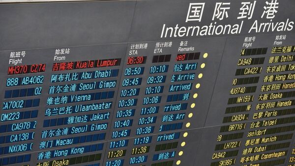 A message is seen to show the delayed arrival of the missing Malaysian flight on an electronic board at the Beijing Capital International Airport in Beijing, capital of China - Sputnik International