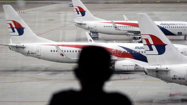 A man views a fleet of Malaysia Airline planes on the tarmac of the Kuala Lumpur International Airport, in Malaysia - Sputnik International