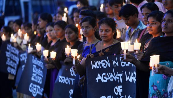 Women hold placards during a silent protest titled Women in Black for Peace on the eve of International Women's Day in Bangalore - Sputnik International