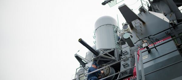 A sailor conducts maintenance on the Phalanx CIWS close-in weapon system aboard the Arleigh Burke-class guided missile destroyer USS Stout at Naval Station Norfolk in Norfolk, Virginia - Sputnik International