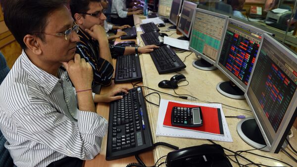 Indian stock dealers watch stock prices on their screen during intra-day trade at a brokerage house in Mumbai - Sputnik International
