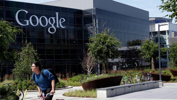 In this June 5 photo, a man rides a bike past a Google sign at the company's headquarters in Mountain View, California. - Sputnik International