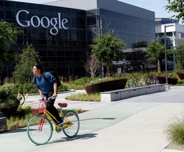 In this June 5 photo, a man rides a bike past a Google sign at the company's headquarters in Mountain View, California. In this June 5 photo, a man rides a bike past a Google sign at the company's headquarters in Mountain View, California. - Sputnik International