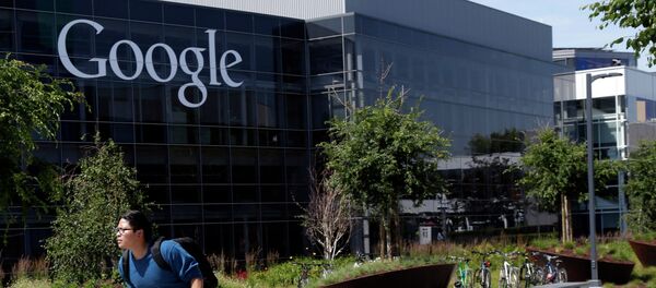 In this June 5 photo, a man rides a bike past a Google sign at the company's headquarters in Mountain View, California. - Sputnik International