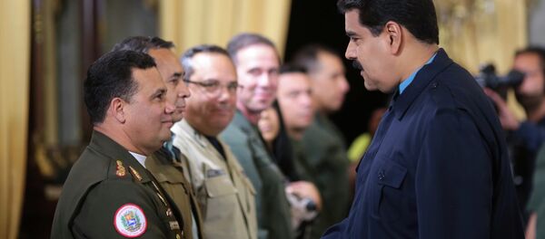 Venezuela's President Nicolas Maduro (R) greets Gustavo Gonzalez as he welcomes army members sanctioned by the U.S. during a national TV broadcast in Caracas in this March 9, 2015 picture provided by Miraflores Palace. Venezuela's President Nicolas Maduro (R) greets Gustavo Gonzalez as he welcomes army members sanctioned by the U.S. during a national TV broadcast in Caracas in this March 9, 2015 picture provided by Miraflores Palace. - Sputnik International