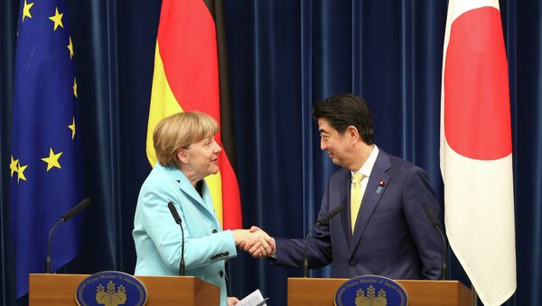 German Chancellor Angela Merkel, left, shakes hands with Japanese Prime Minister Shinzo Abe during a joint press conference at Abe's official residence in Tokyo - Sputnik International