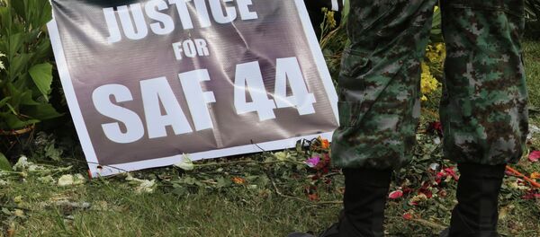 A Philippine police commando stands near a poster calling for justice for 44 commandos killed in a clash with Muslim rebels in January. A Philippine police commando stands near a poster calling for justice for 44 commandos killed in a clash with Muslim rebels in January. - Sputnik International