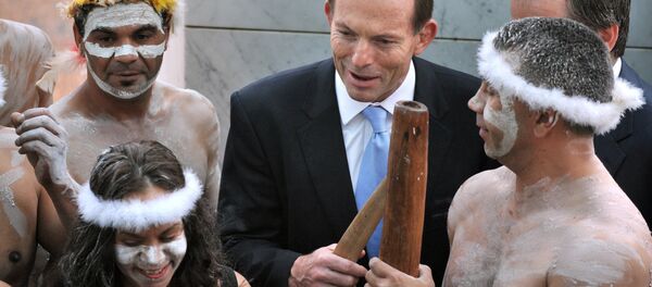 A file photo taken on November 12, 2013, shows Australian Prime Minister Tony Abbott holding his fighting boomerang while talking to an Aboriginal performer at the opening of the 44th Parliament in Canberra. Abbott faced a wave of criticism on March 11, 2015 A file photo taken on November 12, 2013, shows Australian Prime Minister Tony Abbott holding his fighting boomerang while talking to an Aboriginal performer at the opening of the 44th Parliament in Canberra. Abbott faced a wave of criticism on March 11, 2015 - Sputnik International
