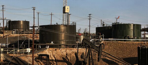 This Thursday March 6, 2014 photo shows pumpjacks operating in front of a hydraulic fracturing site in the Inglewood oil fields in the Baldwin Hills area of Los Angeles - Sputnik International
