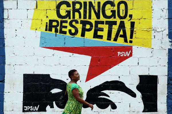 A woman walks past graffiti which reads Gringo, respect us! in Caracas March 10, 2015. President Nicolas Maduro was seeking special decree powers from Venezuela's parliament on Tuesday in response to new U.S. sanctions, drawing opposition protests of a power-grab A woman walks past graffiti which reads Gringo, respect us! in Caracas March 10, 2015. President Nicolas Maduro was seeking special decree powers from Venezuela's parliament on Tuesday in response to new U.S. sanctions, drawing opposition protests of a power-grab - Sputnik International