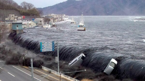 This picture taken by a Miyako City official on March 11, 2011 and released on March 18, 2011 shows a tsunami breeching an embankment and flowing into the city of Miyako in Iwate prefecture shortly after a 9.0 magnitude earthquake hit the region of northern Japan - Sputnik International