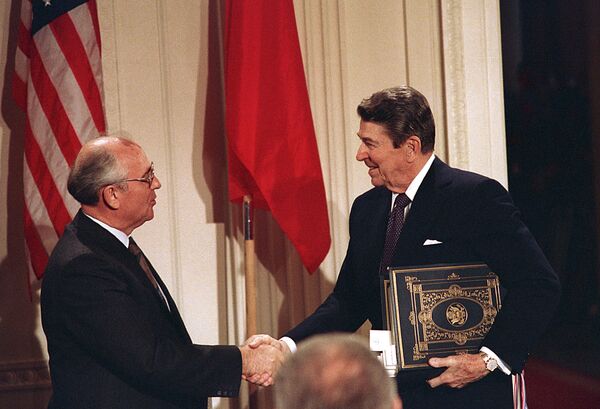 Dec. 8, 1987, file photo, U.S. President Ronald Reagan, right, shakes hands with Soviet leader Mikhail Gorbachev after the two leaders signed the Intermediate Range Nuclear Forces Treaty - Sputnik International