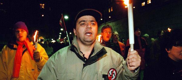 An unidentified protester carries his torch together with some 300 others in a march in Stockholm, Sweden An unidentified protester carries his torch together with some 300 others in a march in Stockholm, Sweden - Sputnik International