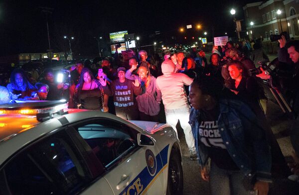 Protestors block a police vehicle from entering the City of Ferguson Police Department and Municipal Court parking lot in Ferguson Missouri, March 11, 2015 Protestors block a police vehicle from entering the City of Ferguson Police Department and Municipal Court parking lot in Ferguson Missouri, March 11, 2015 - Sputnik International