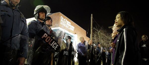 Police and protesters square off outside the Ferguson Police Department, Wednesday, March 11, 2015, in Ferguson, Mo Police and protesters square off outside the Ferguson Police Department, Wednesday, March 11, 2015, in Ferguson, Mo - Sputnik International
