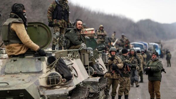 Members of the Ukrainian armed forces and armoured personnel carriers are seen preparing to move as they pull back from Debaltseve region, near Artemivsk February 26, 2015 - Sputnik International