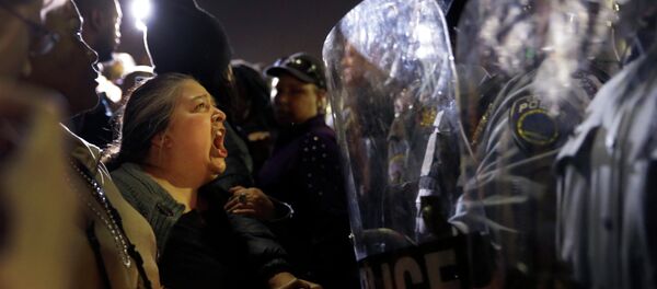 A protester yells at police outside the Ferguson Police Department A protester yells at police outside the Ferguson Police Department - Sputnik International