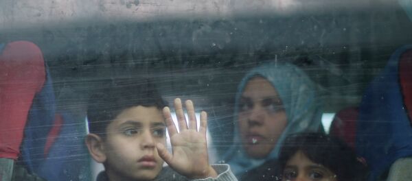 A Palestinian boy looks out a bus window as he waits with family to cross into Egypt, at the Rafah crossing between Egypt and the southern Gaza Strip A Palestinian boy looks out a bus window as he waits with family to cross into Egypt, at the Rafah crossing between Egypt and the southern Gaza Strip - Sputnik International