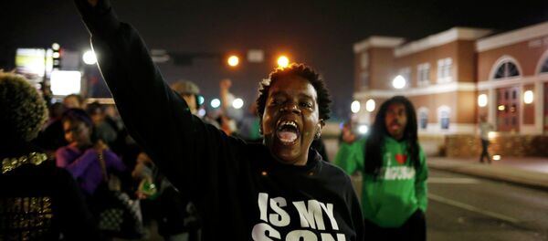 A protestor shouts during a demonstration outside the Ferguson Police Department in Ferguson, Missouri, March 12, 2015 A protestor shouts during a demonstration outside the Ferguson Police Department in Ferguson, Missouri, March 12, 2015 - Sputnik International