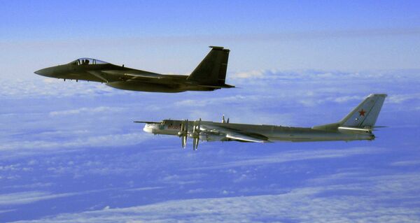 Tu-95 strategic bomber, escorted by a US Air Force F-15C Eagle off the coast of Alaska, 2006. - Sputnik International