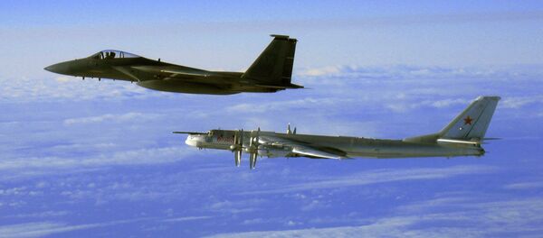 This Thursday, Sept. 28, 2006 file photo provided by the U.S. Air Force shows an F-15C Eagle from the 12th Fighter Squadron at Elmendorf Air Force Base in Anchorage, Alaska, flying next to a Russian Tu-95 Bear bomber, right, during a Russian exercise which brought the bomber near the west coast of Alaska - Sputnik International