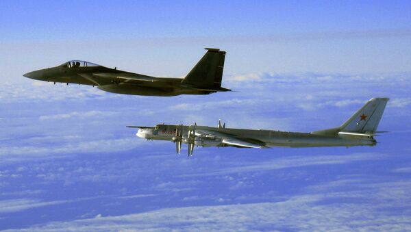 This Thursday, Sept. 28, 2006 file photo provided by the U.S. Air Force shows an F-15C Eagle from the 12th Fighter Squadron at Elmendorf Air Force Base in Anchorage, Alaska, flying next to a Russian Tu-95 Bear bomber, right, during a Russian exercise which brought the bomber near the west coast of Alaska - Sputnik International