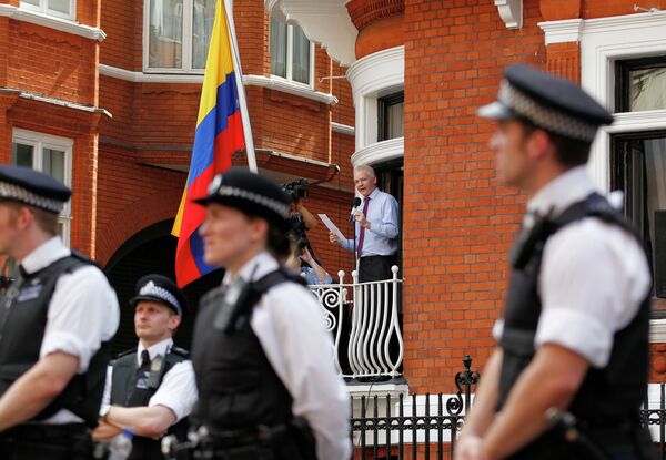 Surrounded by British police WikiLeaks founder Julian Assange, centre, makes a statement to the media and supporters from a window of Ecuadorian Embassy in central London. Surrounded by British police WikiLeaks founder Julian Assange, centre, makes a statement to the media and supporters from a window of Ecuadorian Embassy in central London. - Sputnik International