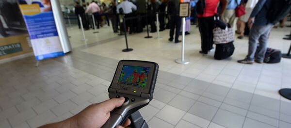 Honduras' Health personnel screen arriving passengers for the deadly Ebola virus at Tegucigalpa's Toncontin international airport on October 20, 2014 Honduras' Health personnel screen arriving passengers for the deadly Ebola virus at Tegucigalpa's Toncontin international airport on October 20, 2014 - Sputnik International