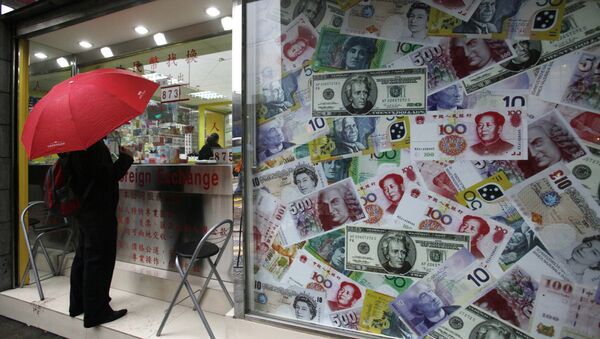 A man stands beside a collage of copies of Chinese RMB, U.S. dollar and other foreign bills at a money exchange store in Hong Kong Thursday, April 15, 2010 - Sputnik International