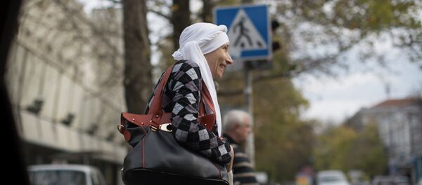 In this photo taken on Thursday, Oct. 23, 2014, a woman in traditional Tatar women's headscarf wait to cross the road in Simferopol, Crimea In this photo taken on Thursday, Oct. 23, 2014, a woman in traditional Tatar women's headscarf wait to cross the road in Simferopol, Crimea - Sputnik International
