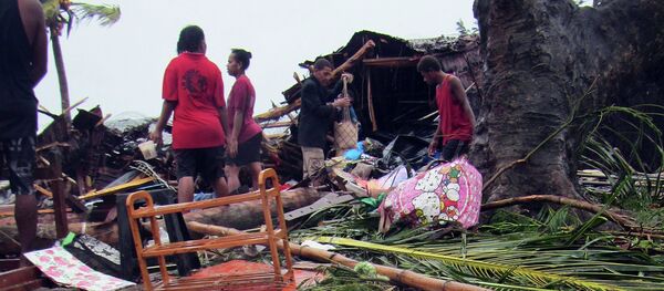 Local residents look through the remains of a small shelter in Port Vila, the capital city of the Pacific island nation of Vanuatu March 14, 2015 Local residents look through the remains of a small shelter in Port Vila, the capital city of the Pacific island nation of Vanuatu March 14, 2015 - Sputnik International