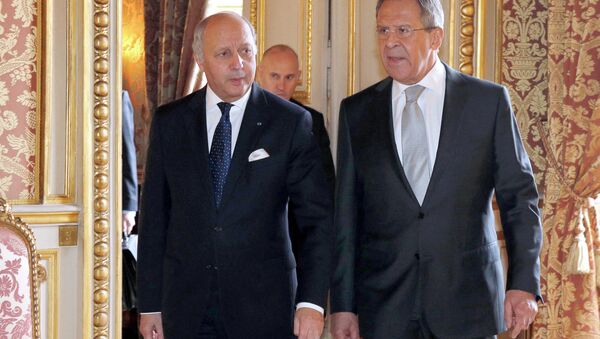 French Foreign Affairs Minister Laurent Fabius, left, walks with his Russian counterpart Sergei Lavrov at the French Foreign Affairs Ministry before a meeting in Paris. - Sputnik International
