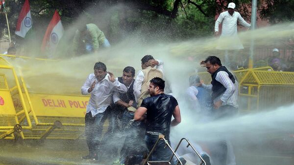Indian police use water cannons to disperse activists of opposition Congress party’s youth wing after they jumped police barricades during a protest against the government’s land acquisition bill, in New Delhi, India - Sputnik International