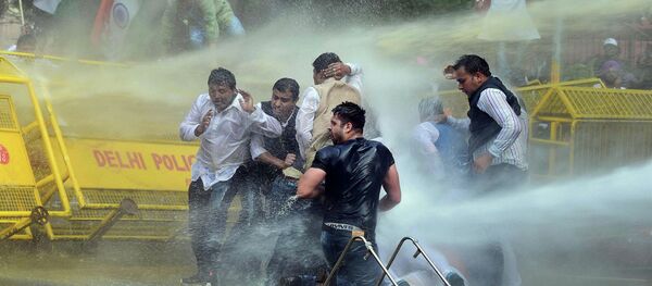 Indian police use water cannons to disperse activists of opposition Congress party’s youth wing after they jumped police barricades during a protest against the government’s land acquisition bill, in New Delhi, India Indian police use water cannons to disperse activists of opposition Congress party’s youth wing after they jumped police barricades during a protest against the government’s land acquisition bill, in New Delhi, India - Sputnik International