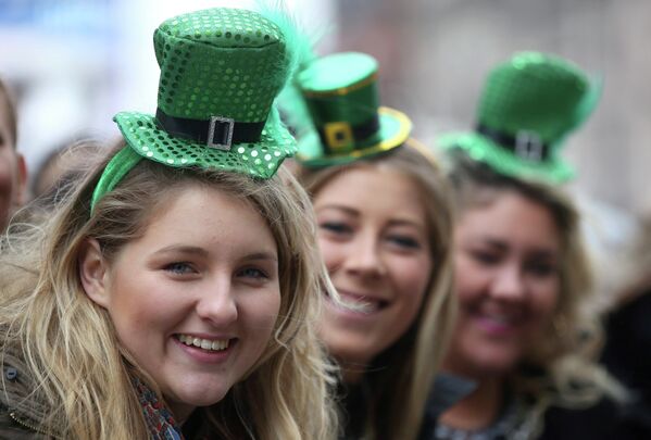Three women take part in the St Patrick's Day parade through central London. - Sputnik International