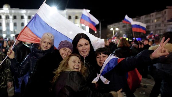 Women pose for a picture during a concert marking the one-year anniversary of Crimea voting to leave Ukraine and join the Russian state, in central Simferopol on March 16, 2015 - Sputnik International