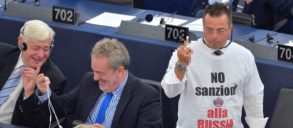 Italian non-affiliated MP Gianluca Buonanno (R), wearing a shirt reading No sanctions to Russia, gestures after a video-link with lawmakers in Kiev during a voting session at the European Parliament, on September 16, 2014, in Strasbourg Italian non-affiliated MP Gianluca Buonanno (R), wearing a shirt reading No sanctions to Russia, gestures after a video-link with lawmakers in Kiev during a voting session at the European Parliament, on September 16, 2014, in Strasbourg - Sputnik International